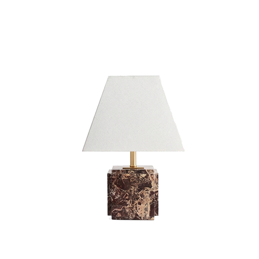 Fatima stepped marble table lamp with linen shade on a white background